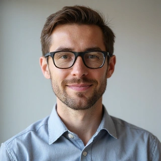 A focused man with a friendly demeanor, representing a logistics and operations manager.